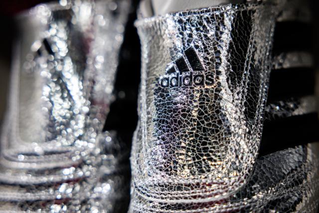04 March 2026, Bavaria, Herzogenaurach: The logo and lettering of sporting goods manufacturer Adidas AG are prominently displayed on the "Adidas Adizero Prime X Evo Unisex" shoe showcased at the company's annual results press conference. Photo: Daniel Karmann/dpa