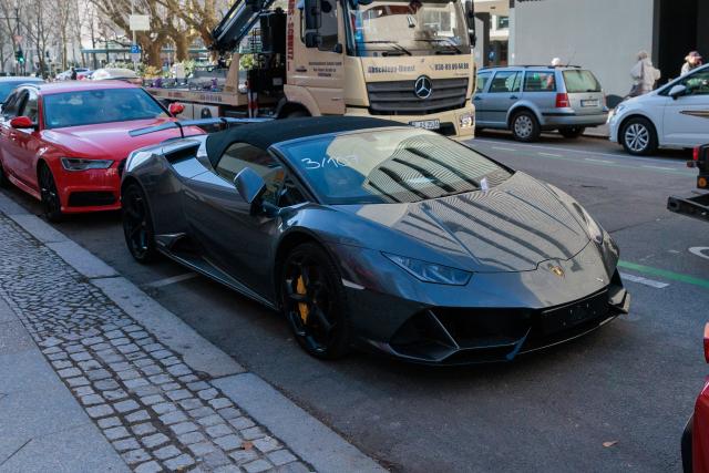 04 March 2026, Berlin: Police officers seize a Ferrari and a Lamborghini as police and tax investigators search several properties. Photo: Carsten Koall/dpa