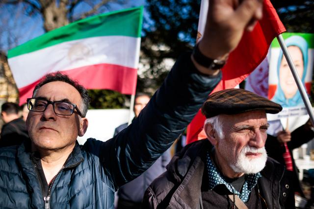 04 March 2026, Berlin: People wave the flags of Iran's National Resistance and hold photos of Maryam Rajavi, the elected president of the National Council of Resistance of Iran, at a rally against the Iranian mullah regime in front of the Embassy of the Islamic Republic of Iran. Photo: Carsten Koall/dpa