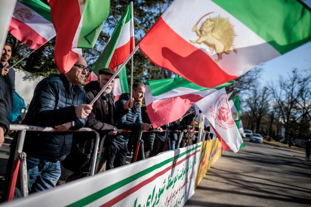 04 March 2026, Berlin: People wave Iranian national resistance flags at a rally against the Iranian mullah regime in front of the Embassy of the Islamic Republic of Iran. Photo: Carsten Koall/dpa