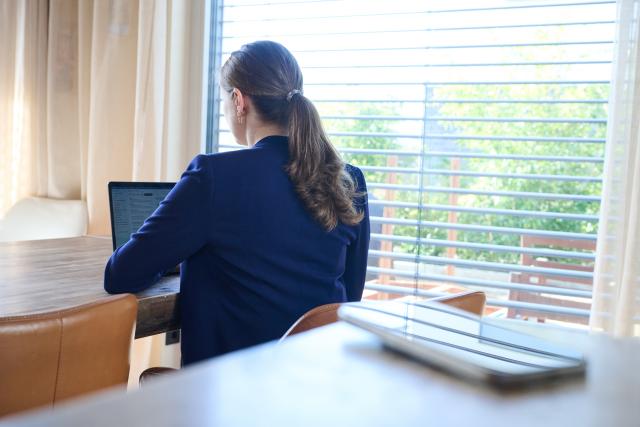 FILED - 25 February 2026, Brandenburg, Zernsdorf: A woman works on a laptop as a smartphone lies on a table. Photo: Annette Riedl/dpa