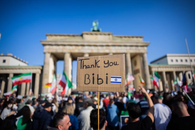 07 March 2026, Berlin: A placard reading "Thank you Bibi" is seen during a protest celebrating the killing of Iran's Supreme Leader Ali Khamenei, at the Brandenburg Gate in Berlin. Photo: Christoph Soeder/dpa
