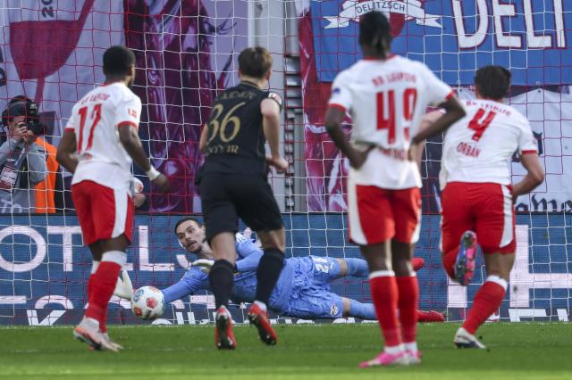 07 March 2026, Saxony, Leipzig: Leipzig goalkeeper Maarten Vandevoordt saves a penalty during the German Bundesliga soccer match between RB Leipzig and FC Augsburg at the Red Bull Arena. Photo: Jan Woitas/dpa - IMPORTANT NOTICE: DFL and DFB regulations prohibit any use of photographs as image sequences and/or quasi-video.