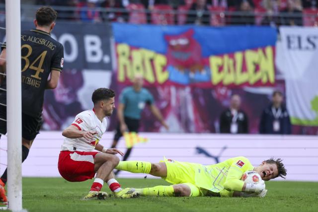 07 March 2026, Saxony, Leipzig: Leipzig's Christoph Baumgartner in action against Augsburg's goalkeeper Finn Dahmen during the German Bundesliga soccer match between RB Leipzig and FC Augsburg at the Red Bull Arena. Photo: Jan Woitas/dpa - IMPORTANT NOTICE: DFL and DFB regulations prohibit any use of photographs as image sequences and/or quasi-video.