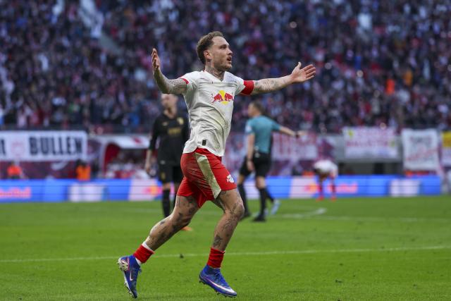07 March 2026, Saxony, Leipzig: Leipzig's David Raum celebrates scoring during the German Bundesliga soccer match between RB Leipzig and FC Augsburg at the Red Bull Arena. Photo: Jan Woitas/dpa - IMPORTANT NOTICE: DFL and DFB regulations prohibit any use of photographs as image sequences and/or quasi-video.