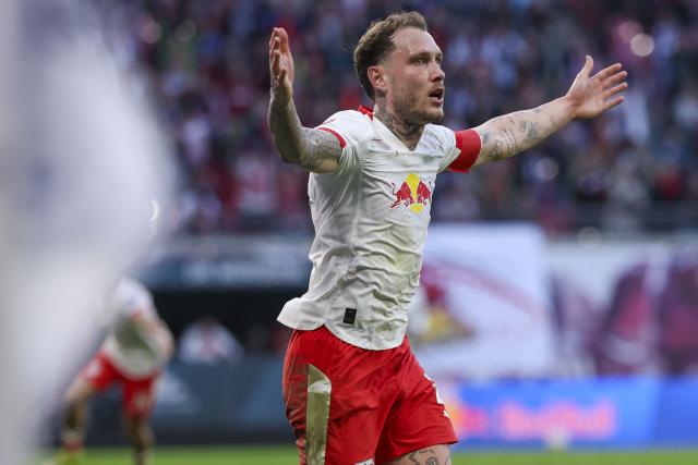 07 March 2026, Saxony, Leipzig: Leipzig's David Raum celebrates scoring during the German Bundesliga soccer match between RB Leipzig and FC Augsburg at the Red Bull Arena. Photo: Jan Woitas/dpa - IMPORTANT NOTICE: DFL and DFB regulations prohibit any use of photographs as image sequences and/or quasi-video.
