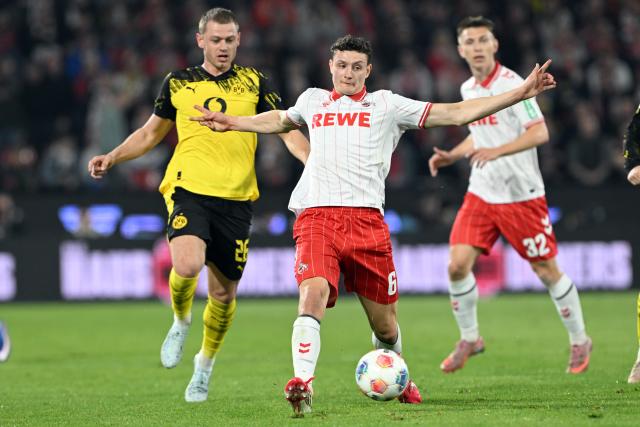 07 March 2026, North Rhine-Westphalia, Cologne: Cologne's Eric Martel and Borussia Dortmund's Julian Ryerson battle for the ball during the German Bundesliga soccer match between 1. FC Cologne and Borussia Dortmund at the RheinEnergieStadion. Photo: Federico Gambarini/dpa - IMPORTANT NOTICE: DFL and DFB regulations prohibit any use of photographs as image sequences and/or quasi-video.