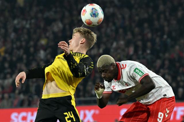 07 March 2026, North Rhine-Westphalia, Cologne: Cologne's Ragnar Ache and Borussia Dortmund's Daniel Svensson battle for the ball during the German Bundesliga soccer match between 1. FC Cologne and Borussia Dortmund at the RheinEnergieStadion. Photo: Federico Gambarini/dpa - IMPORTANT NOTICE: DFL and DFB regulations prohibit any use of photographs as image sequences and/or quasi-video.