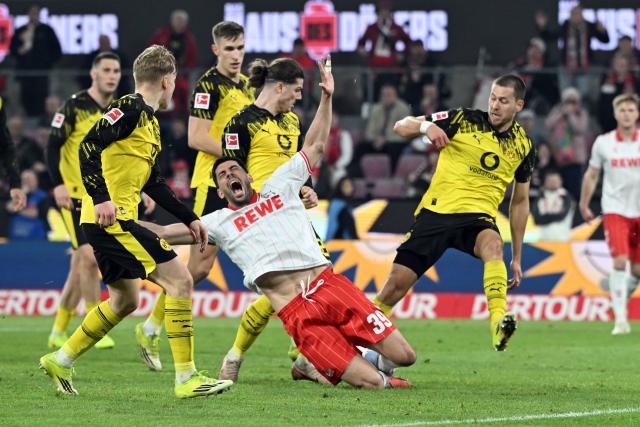 07 March 2026, North Rhine-Westphalia, Cologne: Cologne's Cenk Oezkacar falls in the penalty area during the German Bundesliga soccer match between 1. FC Cologne and Borussia Dortmund at the RheinEnergieStadion. Photo: Federico Gambarini/dpa - IMPORTANT NOTICE: DFL and DFB regulations prohibit any use of photographs as image sequences and/or quasi-video.