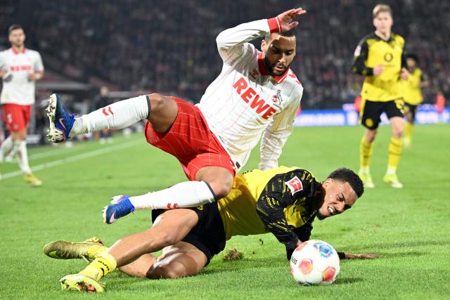 07 March 2026, North Rhine-Westphalia, Cologne: Cologne's Linton Maina and Borussia Dortmund's Felix Nmecha in action during the German Bundesliga soccer match between 1. FC Cologne and Borussia Dortmund at the RheinEnergieStadion. Photo: Federico Gambarini/dpa - IMPORTANT NOTICE: DFL and DFB regulations prohibit any use of photographs as image sequences and/or quasi-video.