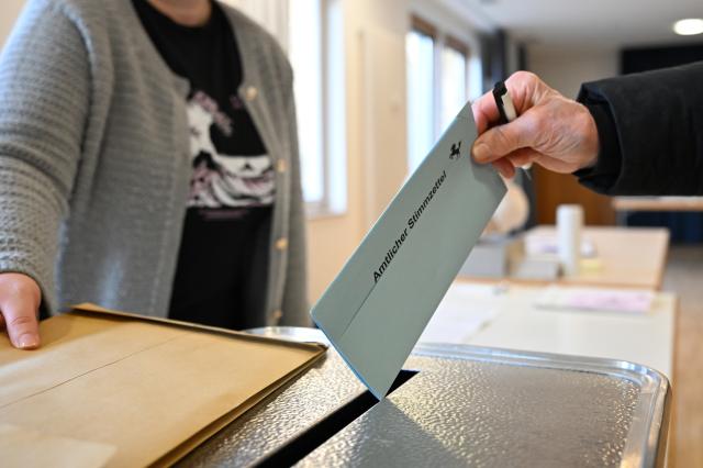 08 March 2026, Baden-Wuerttemberg, Stuttgart: A voter slides his completed ballot paper into a ballot box as Baden-Wuerttemberg prepares to hold its state elections on March 8. Photo: Bernd Weißbrod/dpa