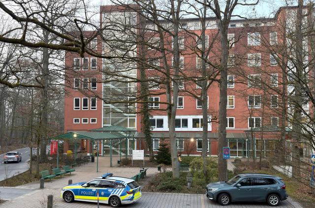 10 March 2026, Bavaria, Erlangen: A police vehicle is parked in front of the Waldkrankenhaus hospital in Erlangen. According to police reports, officers fired their weapons at a 35-year-old man at the Waldkrankenhaus hospital in Erlangen. Photo: Daniel Löb/dpa
