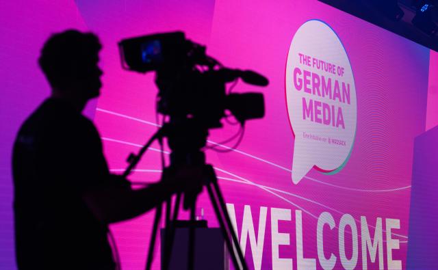12 March 2026, Lower Saxony, Hanover: A cameraman films proceedings at the event "The Future of German Media," held at Madsack's historic printing plant, as the industry gathering focuses on the key success factors for journalism in the digital age. Photo: Julian Stratenschulte/dpa