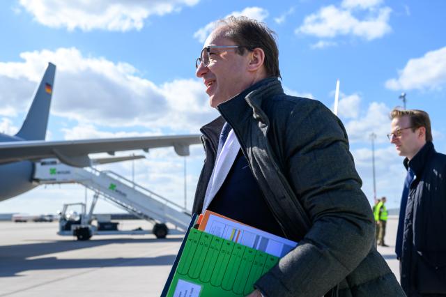 12 March 2026, Brandenburg, Schoenefeld: German Interior Minister Alexander Dobrindt makes his way to the plane at the military section of Berlin Brandenburg Airport ahead of his trip to Norway alongside Federal Chancellor Merz, who makes a stopover in Wiesbaden to attend the ceremony marking the 75th anniversary of the Federal Criminal Police Office (BKA). Photo: Soeren Stache/dpa