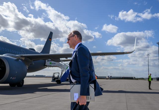 12 March 2026, Brandenburg, Schoenefeld: Germany's Chancellor Friedrich Merz makes his way to the plane at the military section of Berlin Brandenburg Airport ahead of his trip to Norway to attend the ceremony marking the 75th anniversary of the Federal Criminal Police Office (BKA). Photo: Soeren Stache/dpa