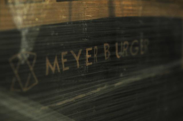FILED - 27 November 2025, Saxony-Anhalt, Bitterfeld-Wolfen: The name "Meyer Burger" can be seen on a foil-wrapped pallet with 30 solar modules. Photo: Simon Kremer/dpa