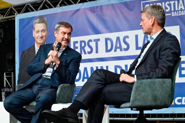 12 March 2026, Rhineland-Palatinate, Frankenthal: Bavarian Minister-President Markus Soeder and CDU politician Christian Baldauf sit on stage in a marquee during an election campaign event in March 2026. Photo: Uwe Anspach/dpa