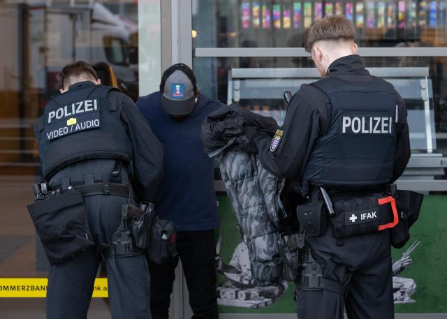 12 March 2026, Hesse, Frankfurt/Main: Police officers handcuff a suspect at Frankfurt's Konstablerwache on March 12, 2026, as part of a large-scale security operation in the city. Photo: Boris Roessler/dpa