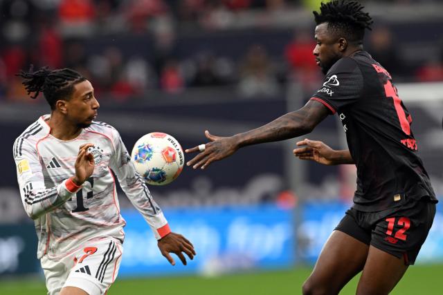 14 March 2026, Leverkusen: Leverkusen's Edmond Tapsoba (R) and Munich's Michael Olise battle for the ball during the German Bundesliga soccer match between Bayer 04 Leverkusen and FC Bayern Munich at the BayArena. Photo: Federico Gambarini/dpa - IMPORTANT NOTE: In accordance with the regulations of the DFL German Football League and the DFB German Football Association, it is prohibited to utilize or have utilized photographs taken in the stadium and/or of the match in the form of sequential images and/or video-like photo series.