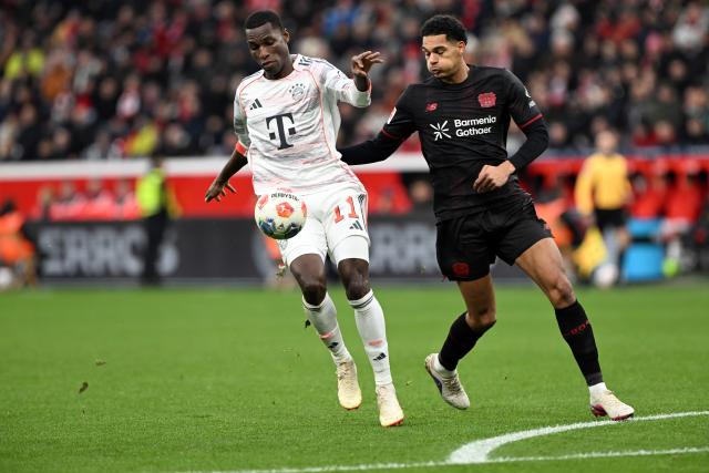 14 March 2026, Leverkusen: Leverkusen's Jarell Quansah (R) and Munich's Nicolas Jackson battle for the ball during the German Bundesliga soccer match between Bayer 04 Leverkusen and FC Bayern Munich at the BayArena. Photo: Federico Gambarini/dpa - IMPORTANT NOTICE: DFL and DFB regulations prohibit any use of photographs as image sequences and/or quasi-video.