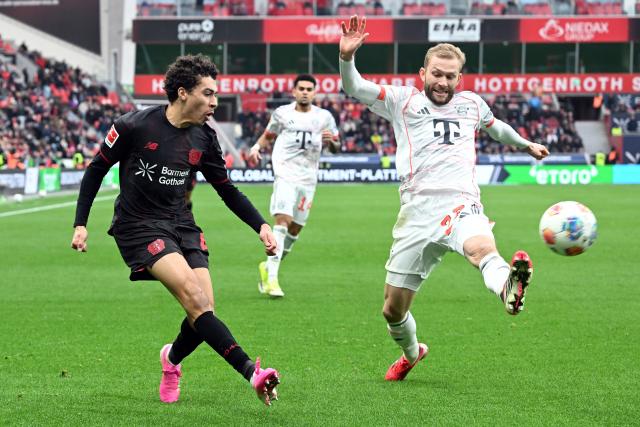 14 March 2026, Leverkusen: Leverkusen's Montrell Culbreath (L) and Munich's Konrad Laimer battle for the ball during the German Bundesliga soccer match between Bayer 04 Leverkusen and FC Bayern Munich at the BayArena. Photo: Federico Gambarini/dpa - IMPORTANT NOTICE: DFL and DFB regulations prohibit any use of photographs as image sequences and/or quasi-video.
