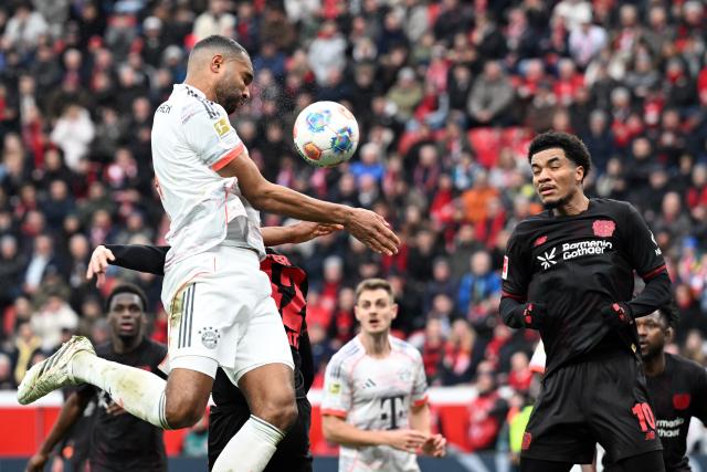 14 March 2026, Leverkusen: Leverkusen's Malik Tillman (R) and Munich's Jonathan Tah battle for the ballduring the German Bundesliga soccer match between Bayer 04 Leverkusen and FC Bayern Munich at the BayArena. Photo: Federico Gambarini/dpa - IMPORTANT NOTICE: DFL and DFB regulations prohibit any use of photographs as image sequences and/or quasi-video.