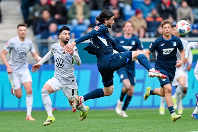 14 March 2026, Baden-Württemberg, Sinsheim: Wolfsburg's Mohamed Amoura (L) and Hoffenheim's Leon Avdullahu battle for the ball during the German Bundesliga soccer match between TSG 1899 Hoffenheim and VfL Wolfsburg at the PreZero Arena. Photo: Uwe Anspach/dpa - IMPORTANT NOTICE: DFL and DFB regulations prohibit any use of photographs as image sequences and/or quasi-video.