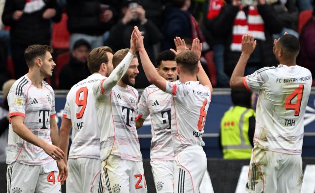 14 March 2026, Leverkusen: Bayern players celebrate a goal during the German Bundesliga soccer match between Bayer 04 Leverkusen and FC Bayern Munich at the BayArena. Photo: Federico Gambarini/dpa - IMPORTANT NOTICE: DFL and DFB regulations prohibit any use of photographs as image sequences and/or quasi-video.