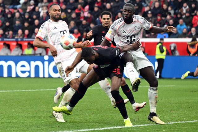 14 March 2026, Leverkusen: Leverkusen's Christian Kofane and Munich's Dayot Upamecano battle for the ball during the German Bundesliga soccer match between Bayer 04 Leverkusen and FC Bayern Munich at the BayArena. Photo: Federico Gambarini/dpa - IMPORTANT NOTICE: DFL and DFB regulations prohibit any use of photographs as image sequences and/or quasi-video.