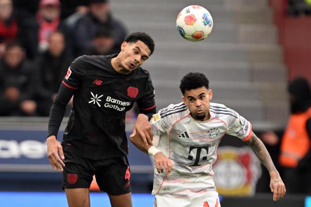 14 March 2026, Leverkusen: Leverkusen's Jarell Quansah (L) and Bayern Munich's Luis Diaz battle for the ball during the German Bundesliga soccer match between Bayer 04 Leverkusen and FC Bayern Munich at the BayArena. Photo: Federico Gambarini/dpa - IMPORTANT NOTICE: DFL and DFB regulations prohibit any use of photographs as image sequences and/or quasi-video.