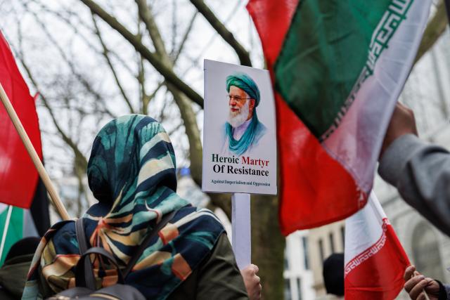 14 March 2026, Hesse, Frankfurt/Main: A participant holds a picture of slain Iranian Supreme leader Ali Khamenei during the "Stop Zionism - Solidarity with Palestine & Iran" demonstration. Photo: Hannes P Albert/dpa