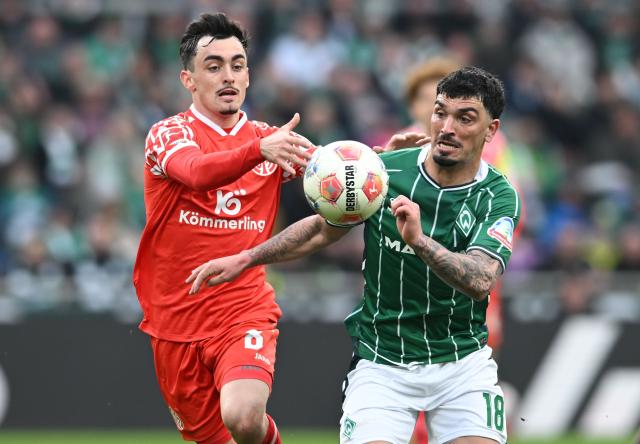 15 March 2026, Bremen: Werder Bremen's Cameron Puertas (R) and Mainz's Paul Nebel battle for the ball during the German Bundesliga soccer match between Werder Bremen and FSV Mainz 05 at Weserstadion. Photo: Carmen Jaspersen/dpa - WICHTIGER HINWEIS: Gemäß den Vorgaben der DFL Deutsche Fußball Liga bzw. des DFB Deutscher Fußball-Bund ist es untersagt, in dem Stadion und/oder vom Spiel angefertigte Fotoaufnahmen in Form von Sequenzbildern und/oder videoähnlichen Fotostrecken zu verwerten bzw. verwerten zu lassen.