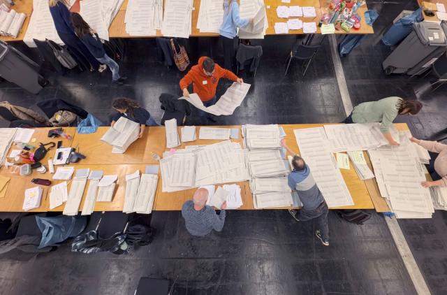 15 March 2026, Hesse, Frankfurt/Main: Officials count ballots at the mail-in voting center in the exhibition halls for the local elections in Hesse. Photo: Andreas Arnold/dpa