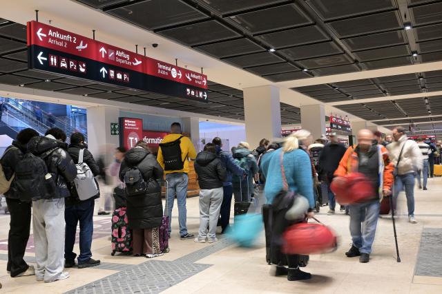 FILED - 06 February 2026, Berlin: People stand in the terminal at Berlin's BER airport. A strike will halt all passenger flights at Berlin's airport on Wednesday, affecting 445 take-offs and landings and roughly 57,000 passengers, the operator said. Photo: Michael Bahlo/dpa