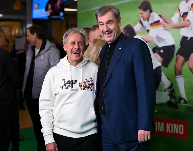 16 March 2026, Bavaria, Munich: German association football manager Pierre Littbarski (L) and Minister President of Bavaria Markus Soeder arrive to attend the premiere of the documentary "A Summer in Italy - 1990 World Cup" at the Mathaeser Filmpalast. Photo: Sven Hoppe/dpa