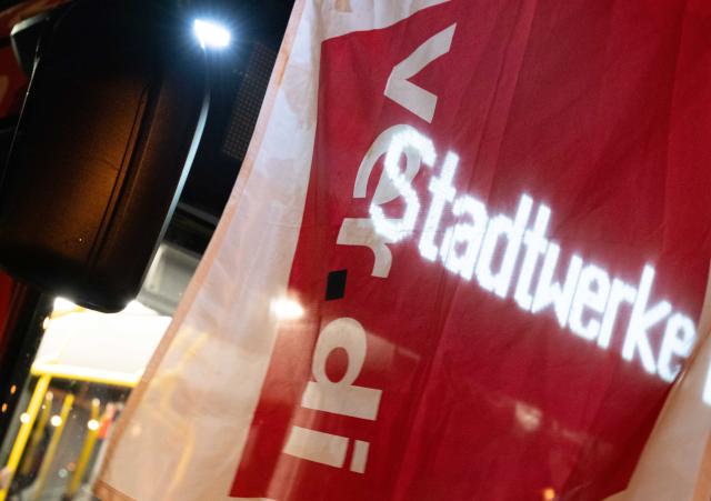 17 March 2026, North Rhine-Westphalia, Bonn: A Verdi union flag outside the Bonn Public Utilities depot signals an ongoing warning strike. Photo: Benjamin Westhoff/dpa