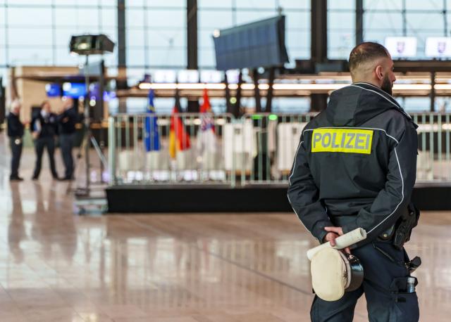 FILED - 16 December 2025, Hesse, Frankfurt/Main: A police officer stands in the new Terminal 3, which has not yet opened. Two people have been shot dead in a bistro in Raunheim near Frankfurt Airport, German police have said. Photo: Andreas Arnold/dpa