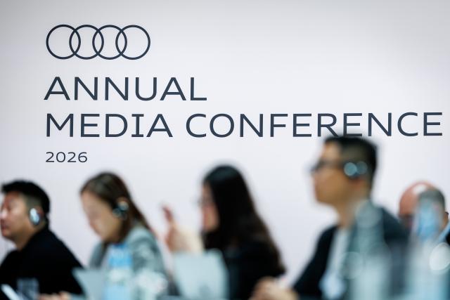 17 March 2026, Bavaria, Ingolstadt: Journalists follow the annual press conference of the car manufacturer Audi. Photo: Daniel Karmann/dpa