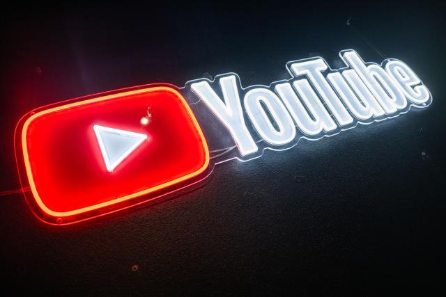 FILED - 25 February 2026, Berlin: A YouTube logo hangs on the wall during the YouTube Podcast Awards ceremony in Berlin. Photo: Christophe Gateau/dpa