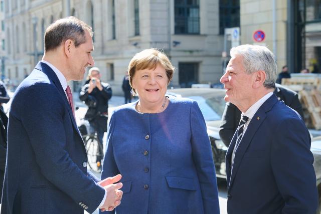 18 March 2026, Berlin: Former German President Joachim Gauck (R) and former Chancellor Angela Merkel greet Michael Mronz, Former partner of Free Democratic Party (FDP) politician Guido Westerwelle, at the memorial service marking the 10th anniversary of the FDP politician's death. Photo: Annette Riedl/dpa