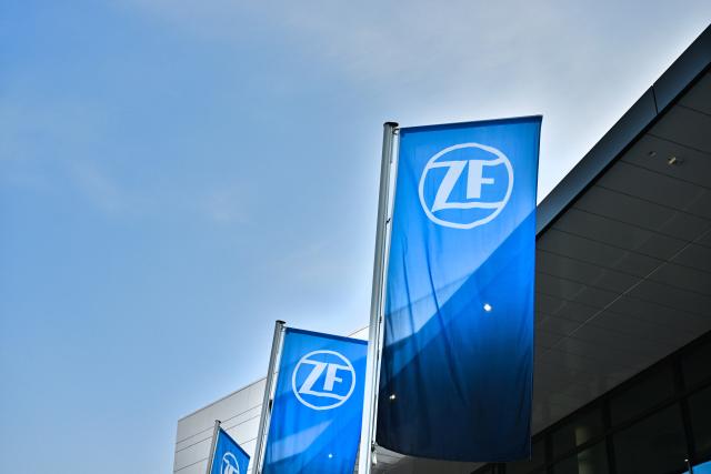 19 March 2026, Baden-Württemberg, Friedrichshafen: Flags with the ZF Friedrichshafen AG logo fly in front of the automotive supplier's forum. Photo: Felix Kästle/dpa