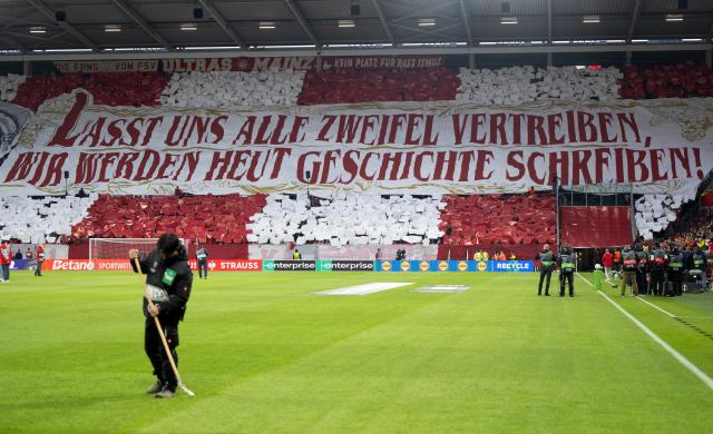 19 March 2026, Rheinland-Pfalz, Mainz: Mainz fans display a banner reading, "Let's banish all doubt-we're going to make history today!" ahead of the UEFA Europa Conference League round of 16 second leg soccer match between FSV Mainz 05 and Sigma Olomouc at Mewa Arena. Photo: Torsten Silz/dpa
