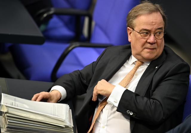 20 March 2026, Berlin: Armin Laschet sits in front of a pile of files in the plenary chamber of the Bundestag. Photo: Lilli Förter/dpa
