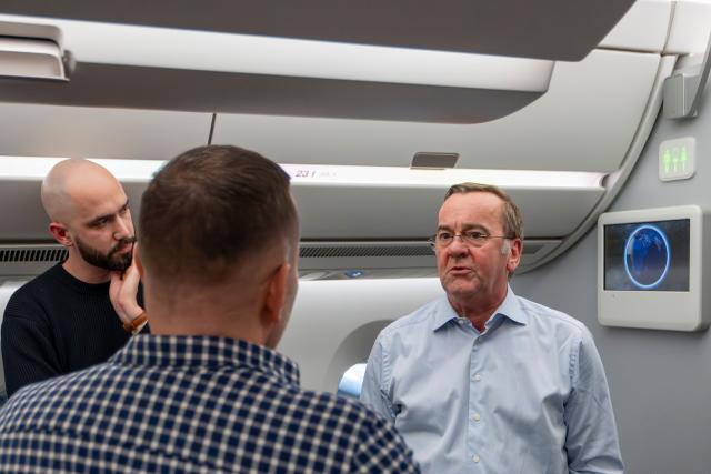 20 March 2026, Brandenburg, Schoenefeld: German Minister of Defense Boris Pistorius (R) speaks with the journalists traveling with him before the start of his military policy trip to Asia. Photo: Peter Kneffel/dpa