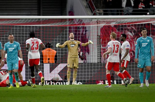 20 March 2026, Saxony, Leipzig: Hoffenheim goalkeeper Oliver Baumann (C) reacts after conceding the third goal during the German Bundesliga soccer match between RB Leipzig and TSG 1899 Hoffenheim at Red Bull Arena. Photo: Julius Frick/dpa