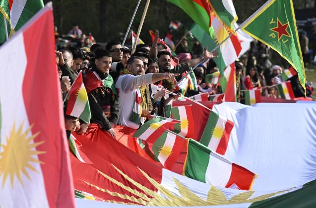 21 March 2026, North Rhine-Westphalia, Bonn: Kurds celebrate the Kurdish New Year (Newroz) festival at a demonstration on the situation in Syria in the Rheinaue. Several thousand Kurds came from all over Germany and nearby countries to celebrate together. Photo: Roberto Pfeil/dpa