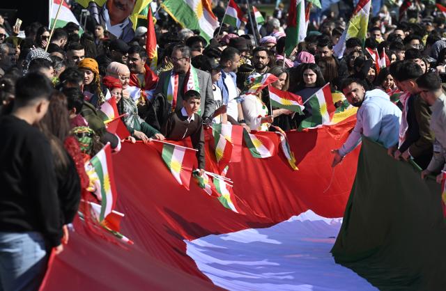 21 March 2026, North Rhine-Westphalia, Bonn: Kurds celebrate the Kurdish New Year (Newroz) festival at a demonstration on the situation in Syria in the Rheinaue. Several thousand Kurds came from all over Germany and nearby countries to celebrate together. Photo: Roberto Pfeil/dpa