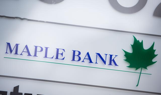 FILED - 07 February 2016, Hesse, Frankfurt_Main: The Maple Bank logo can be seen at the entrance to the bank's offices in Frankfurt am Main's Westend district. Photo: picture alliance / dpa