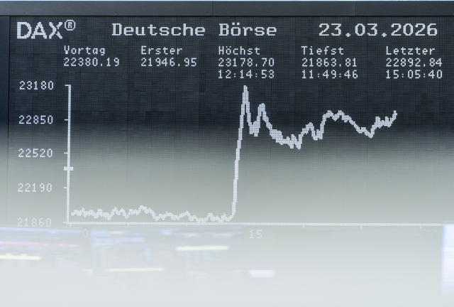 23 March 2026, Hesse, Frankfurt_Main: The daily performance of the German share index (Dax) can be seen on the large display board above the trading floor. Photo: Andreas Arnold/dpa