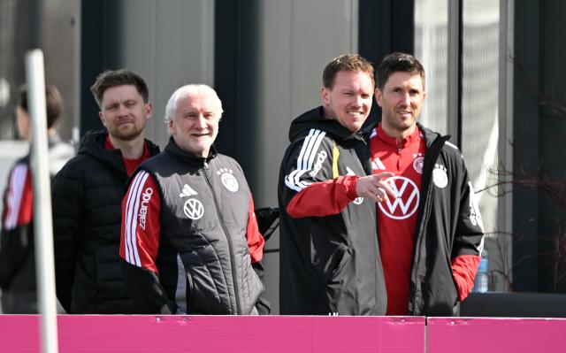 24 March 2026, Bavaria, Herzogenaurach: (L-R) Rudi Voeller, director of the German national team,   German national team coach Julian Nagelsmann and Benjamin Glueck, assistant coach arrive to the team's training session ahead of the FIFA World Cup qualifying soccer match against Switzerland. Photo: Federico Gambarini/dpa